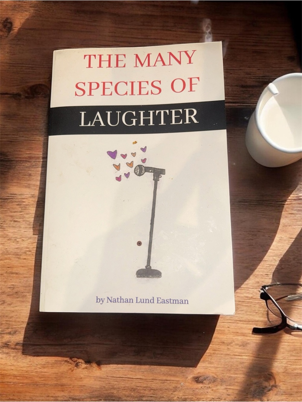 The Many Species of Laughter Paperback — White Cover with Black and Red Text